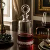 Decorative red wine decanter bottle with thick glass base and classic clear body
