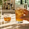 Vertical ribbed drinking glasses with textured surface and thick clear base