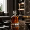 Decorative clear liquor decanter with rounded body and vertical glass detailing