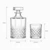 Clear whiskey decanter with four decorative patterned whiskey tumblers