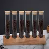 Modern coffee storage display stand with clear glass tubes and natural wooden base
