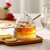 Elegant beehive glass honey jar with lid and wooden honey dipper for kitchen and dining use