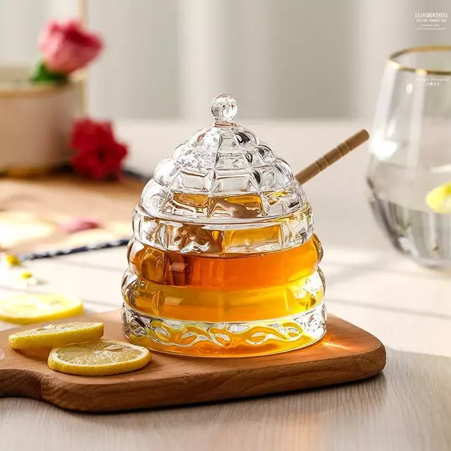 Elegant beehive glass honey jar with lid and wooden honey dipper for kitchen and dining use