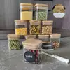 Borosilicate glass jars with natural bamboo lids and chalkboard labels, storing pasta and cereal.