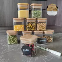 Borosilicate glass jars with natural bamboo lids and chalkboard labels, storing pasta and cereal.