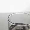 Nordic style sculpted water glass on a minimalist table setting with natural lighting