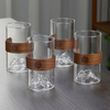 Unique mountain-inspired glass cup featuring a protective wooden sleeve, ideal for hot or cold beverages, modern kitchen décor