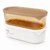 1090ml oval stackable food storage container with beige lid transparent amber upper section removable drain tray and white base