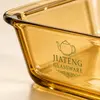 Transparent amber rectangular glass oven dish measuring 38.6 by 24.6 by 7cm with a spacious interior and rounded corners.