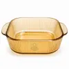 2.4L amber square borosilicate glass baking dish with vertical fluted texture and integrated side handles for oven cooking.