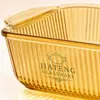 Transparent amber borosilicate glass baking dish featuring decorative vertical ribbed walls, rounded corners and a spacious rectangular body.