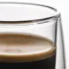Transparent handleless coffee tumbler with rounded outer base and suspended inner beverage chamber