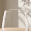 Modern clear stemless glass tumbler with gently tapered upper body