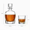 Round shoulder glass whiskey decanter with four matching short tumblers
