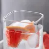 Transparent square glass cup with rounded square opening for water juice and iced beverages