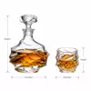 Irregular shaped whiskey decanter with four decorative whiskey glasses