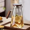 Clear glass pitcher with filter lid and wooden style side handle