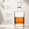 Modern liquor serving bottle with transparent glass design and decorative stopper
