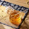 Premium glass honey pot with matching lid and wooden dipper for serving natural honey