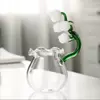 Artistic floral glass tea cup featuring a decorative lily flower stem and crystal-clear bowl