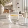 Clear rounded drinking glass displayed beside white Jiateng Glassware branded packaging box