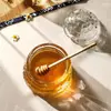 Decorative honey storage glass jar designed for honey, syrup, and sweet sauces