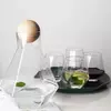 Modern iridescent glass water pitcher with wooden lid for stylish beverage serving
