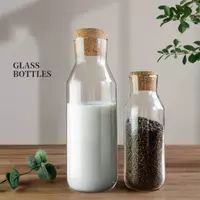 Transparent glass bottles with natural cork stoppers, airtight and leakproof design, perfect for storing milk, juice, dry fruits, or grains in the kitchen