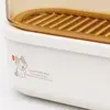 Oval kitchen food storage container featuring a removable raised draining tray inside the transparent amber compartment