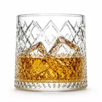 Diamond cut mountain whiskey glass with textured geometric pattern and landscape design