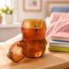 Bear shaped glass cup with lid and playful cartoon face design