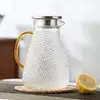 Stylish gold handle glass carafe designed for juice, lemonade, iced tea, and everyday beverages