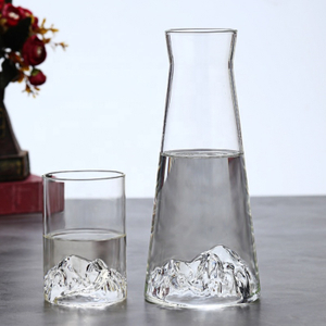 Clear glass pitcher and matching tumbler with mountain-shaped base, perfect for water, juice, or cocktails, stylish home tableware