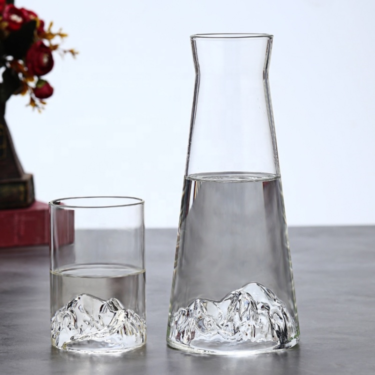 Clear glass pitcher and matching tumbler with mountain-shaped base, perfect for water, juice, or cocktails, stylish home tableware