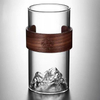 Clear glass cup with 3D mountain-shaped base and wooden sleeve, perfect for tea, water, or juice, stylish and safe for home use