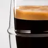 Clear double wall drinking glass featuring a distinctive raised circular band around the middle of the body
