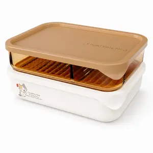 Two sizes of rectangular stackable food storage containers with amber lids, transparent middle sections and removable grid trays.
