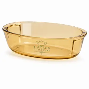 Amber oval borosilicate glass baking dish with integrated side handles and 1.7L capacity for oven cooking.