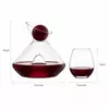 sculptural glass red wine decanter with four clear stemless wine glasses for elegant serving