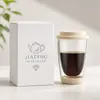 Reusable transparent borosilicate coffee cup with double wall construction cream silicone lid and protective bottom sleeve
