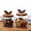 Jiateng decorative glass snack storage jar with handcrafted wooden leaf lid