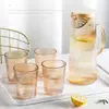 Heat-resistant glass juice pitcher featuring a modern ribbed texture and ergonomic handle