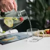 Modern glass carafe with cup featuring a compact stackable design for everyday use
