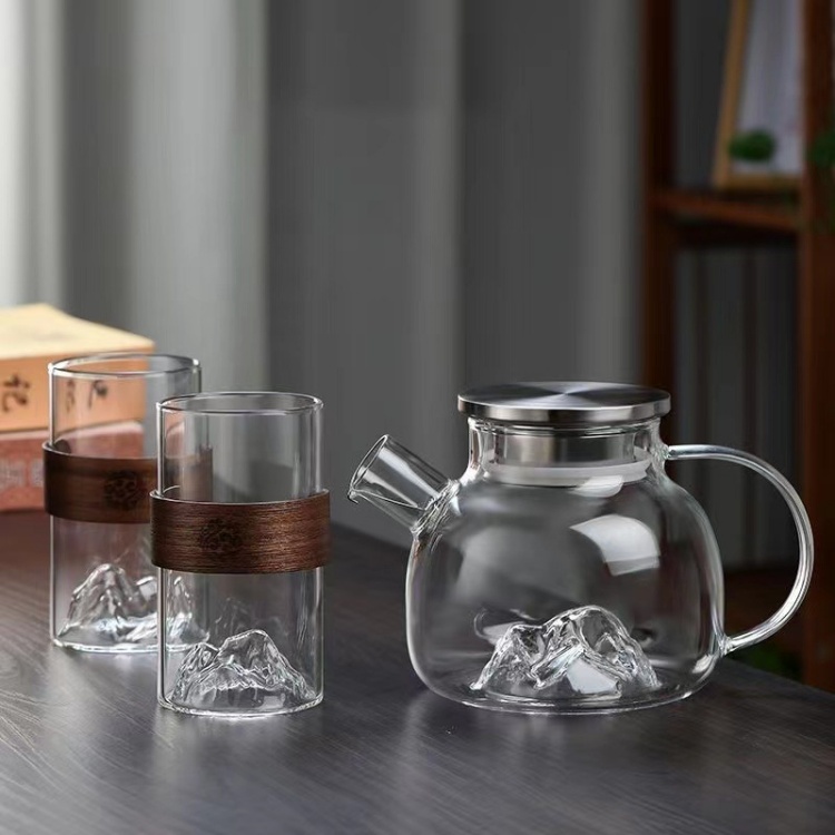 Glass cup with embossed mountain base and elegant wooden sleeve, suitable for everyday drinking, tea ceremonies, or gifting