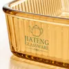 Rectangular amber glass oven dish measuring 27.0 by 15.7 by 5.6cm with integrated side handles for convenient kitchen use.
