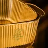 Square amber glass oven dish measuring 25.3 by 25.3 by 6.7cm with two integrated side handles.