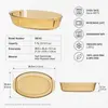 Transparent amber glass oven dish featuring an oval body, shallow baking profile and two side handles.