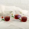 Daisy handle glass cup with transparent body and creative flower design