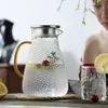 Elegant hammered glass beverage pitcher with gold handle for modern kitchen and dining use