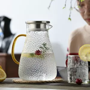 Elegant hammered glass beverage pitcher with gold handle for modern kitchen and dining use